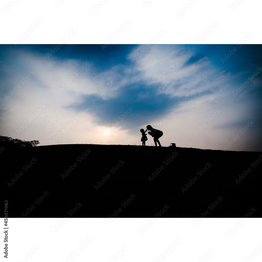 silhouette of a person on a bicycle