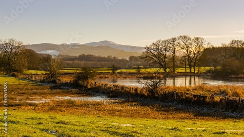 The River Dee in winter with a snow covered Bengairn Hill in the background