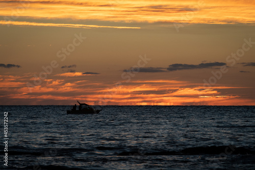 Boat silhouette on the ocean at sunset © Isaac