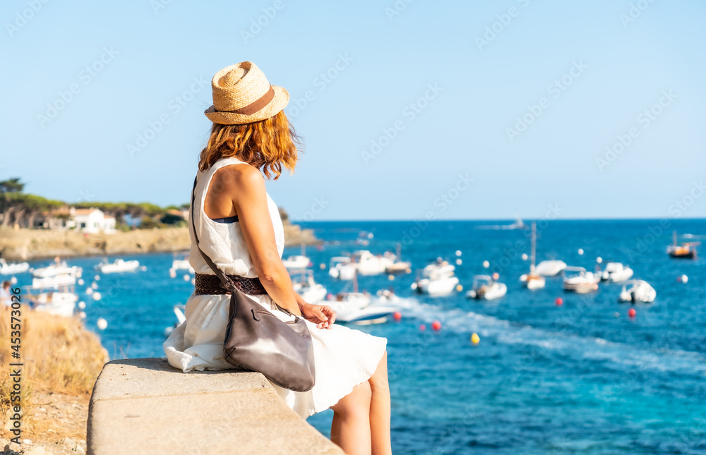A young woman on vacation in Cadaques, Costa Brava of Catalonia, Gerona, Mediterranean Sea. Spain
