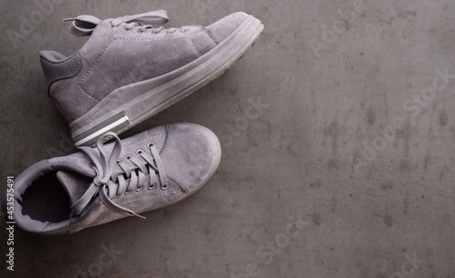 Gray sneakers on a dark background. Modern, casual footwear.