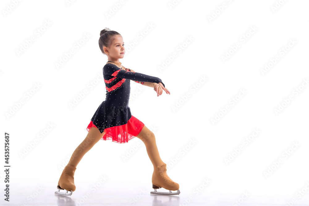 Little skater posing in red and black dress on ice isolat on white background
