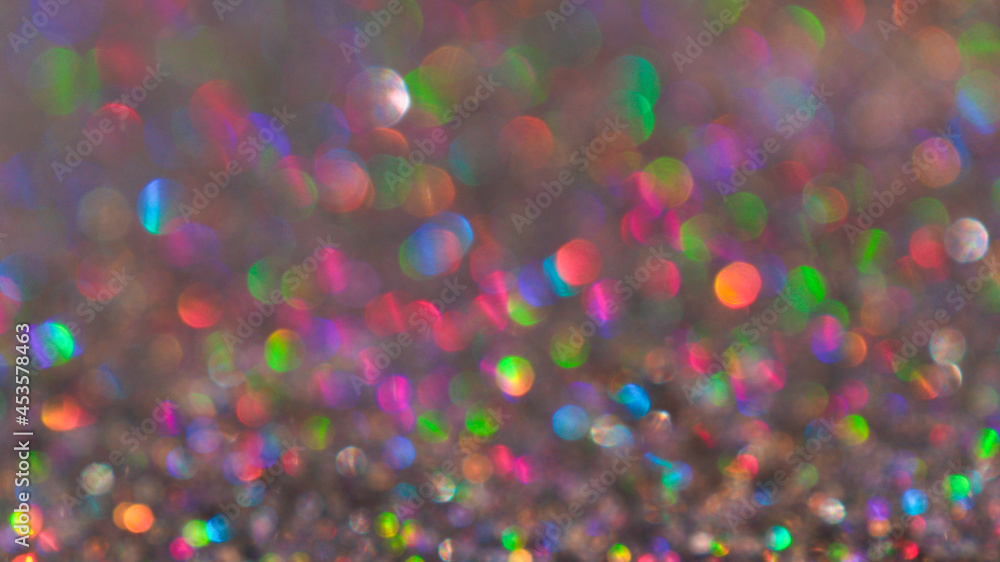 Colorful twinkle blurred glitter background. Abstract festive background with bright lights