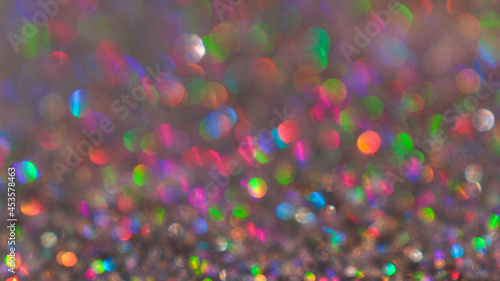 Obraz na płótnie Colorful twinkle blurred glitter background. Abstract festive background with bright lights w salonie