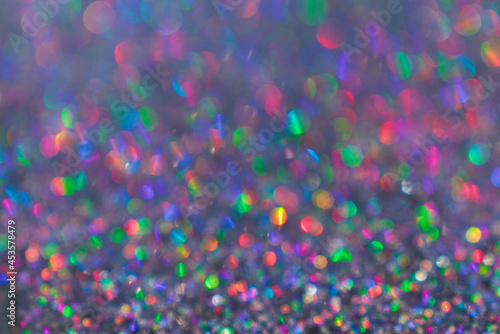 Colorful twinkle blurred glitter background. Abstract festive background with bright lights 