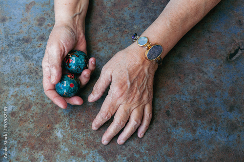 hands of senior adult woman excercising with chinese baoding balls for stress relief and deep relaxation photo