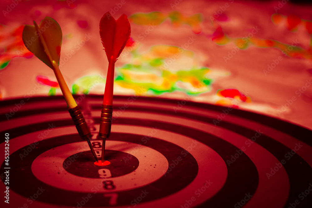 Close up shot of the dart arrow hit on bulleyes of dartboard to represent that the business reached the target of company with dark tone picture style. Target and goal as concept.
Close up shot of the dart arrow hit on bulleyes of dartboard to represent that the business reached the target of company with dark tone picture style. Target and goal as concept.