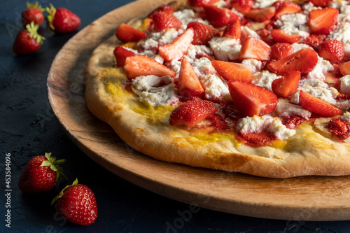 Strawberry and banana pizza with ricotta cheese and mango sauce.