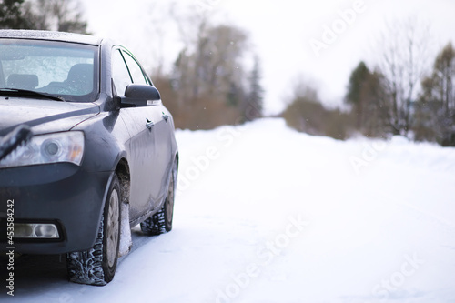 Modern car stay on roadside of winter road. Family trip to ski resort concept. Winter or spring holidays adventure. car on winter snowy road © alexkich