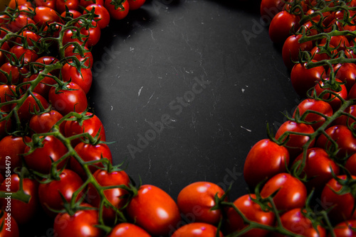 Tomatoes on wood background. Close-up of bio fresh vegetables. Group of summer tomatoes. Space for text top view