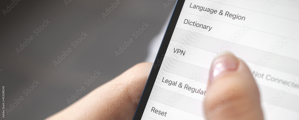 Person turn on the VPN setting on mobile phone, close-up, banner design photo Person turn on the VPN setting on mobile phone, close-up, banner design photo