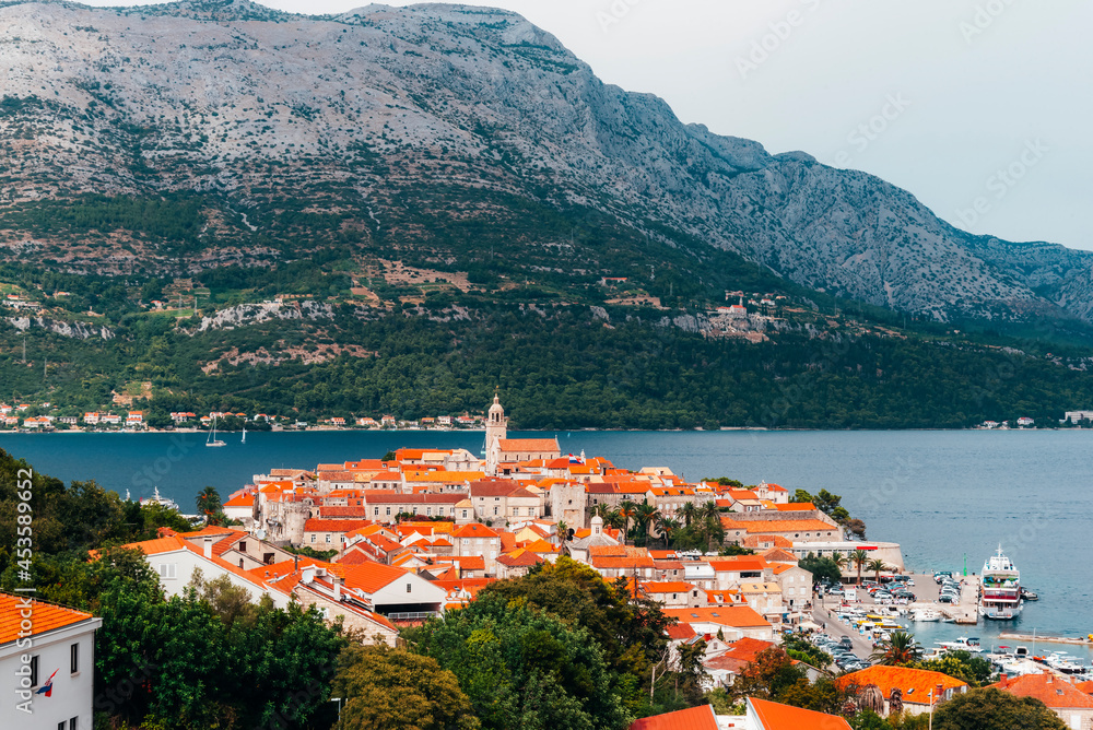 Old town of Korcula on the background of the mountains of Peljesac peninsula, Adriatic sea, Croatia