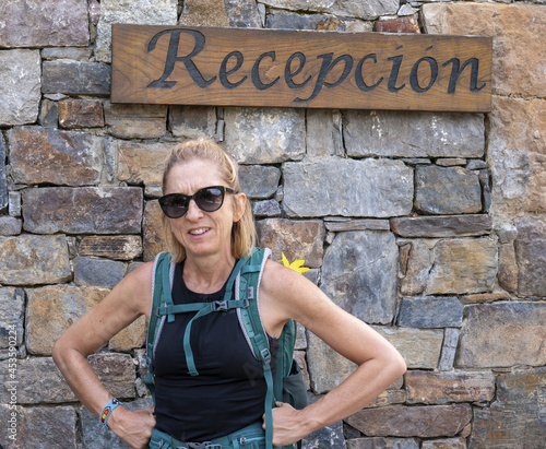 Closeup shot of a hiker woman standing under the sign 