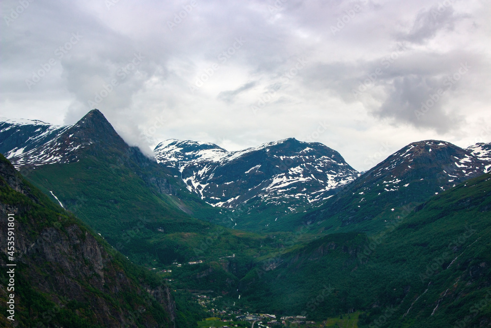 Beautiful landscape with mountains and grey clouds in Norway, Geirangerfjord