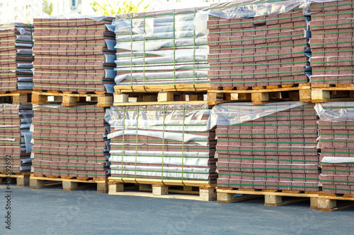 Dark red paving flags stacked on pallets.