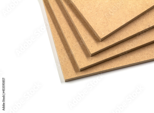 Four boards of raw MDF arranged irregularly, one on top of the other.