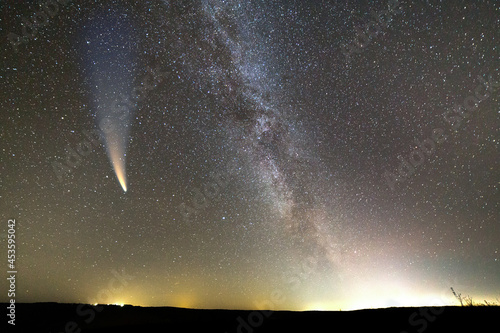 Billede på lærred Night landscape of dark hill with stars covered sky and Neowise comet with light tail