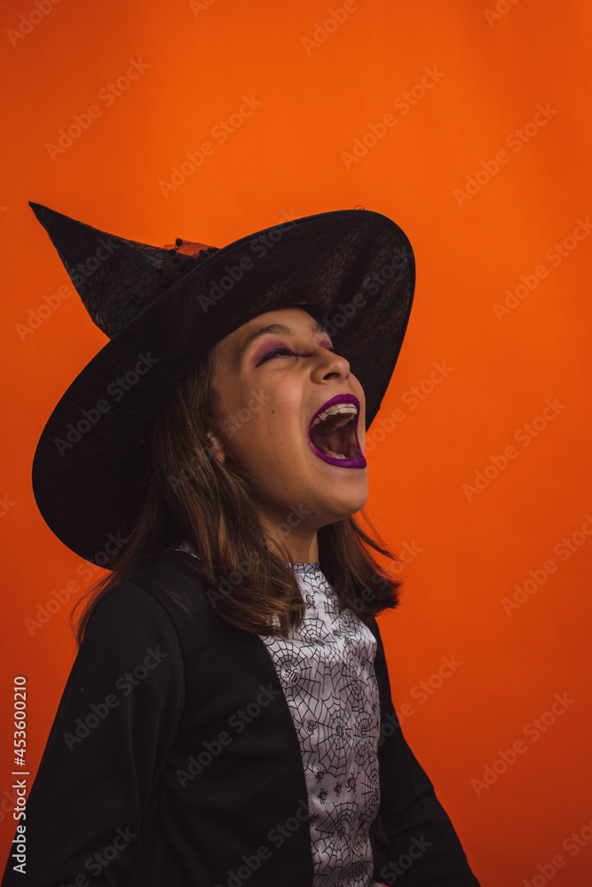 Portrait of a witch laughing with her evil laugh because it is already Halloween Portrait of a witch laughing with her evil laugh because it is already Halloween