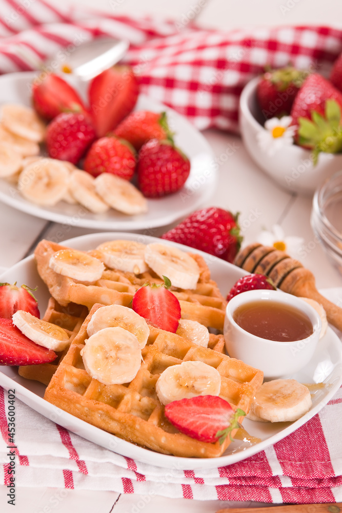 Waffles with strawberries, bananas and honey. Waffles with strawberries, bananas and honey.
