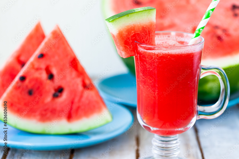 Delicious healthy refreshing low calories summer drink: watermelon smoothie or juice. Concept of seasonal desserts, detox, dieting. White wooden background, close up, macro Delicious healthy refreshing low calories summer drink: watermelon smoothie or juice. Concept of seasonal desserts, detox, dieting. White wooden background, close up, macro