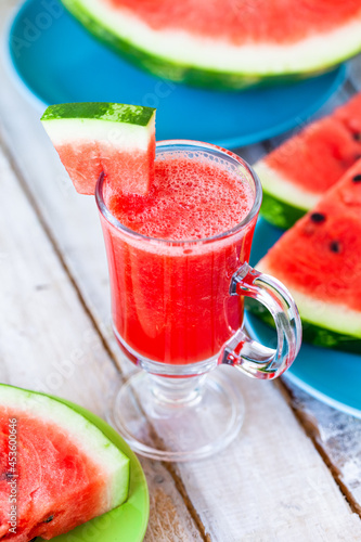 Delicious healthy refreshing low calories summer drink: watermelon smoothie or juice. Concept of seasonal desserts, detox, dieting. White wooden background, close up, macro