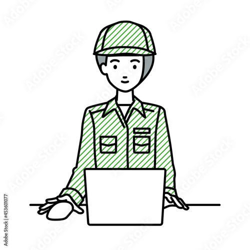 デスクで座ってPCを使っている作業員の女性