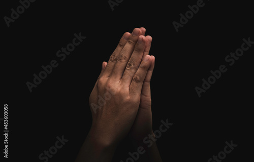Two hand praying pay respect on dark background , this action for Thailand culture concept.