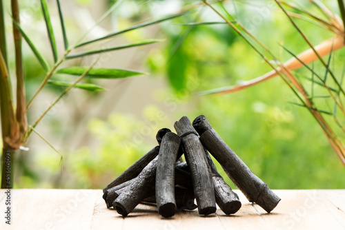 Bamboo charcoal  green leaves and powder isolated on nature background.