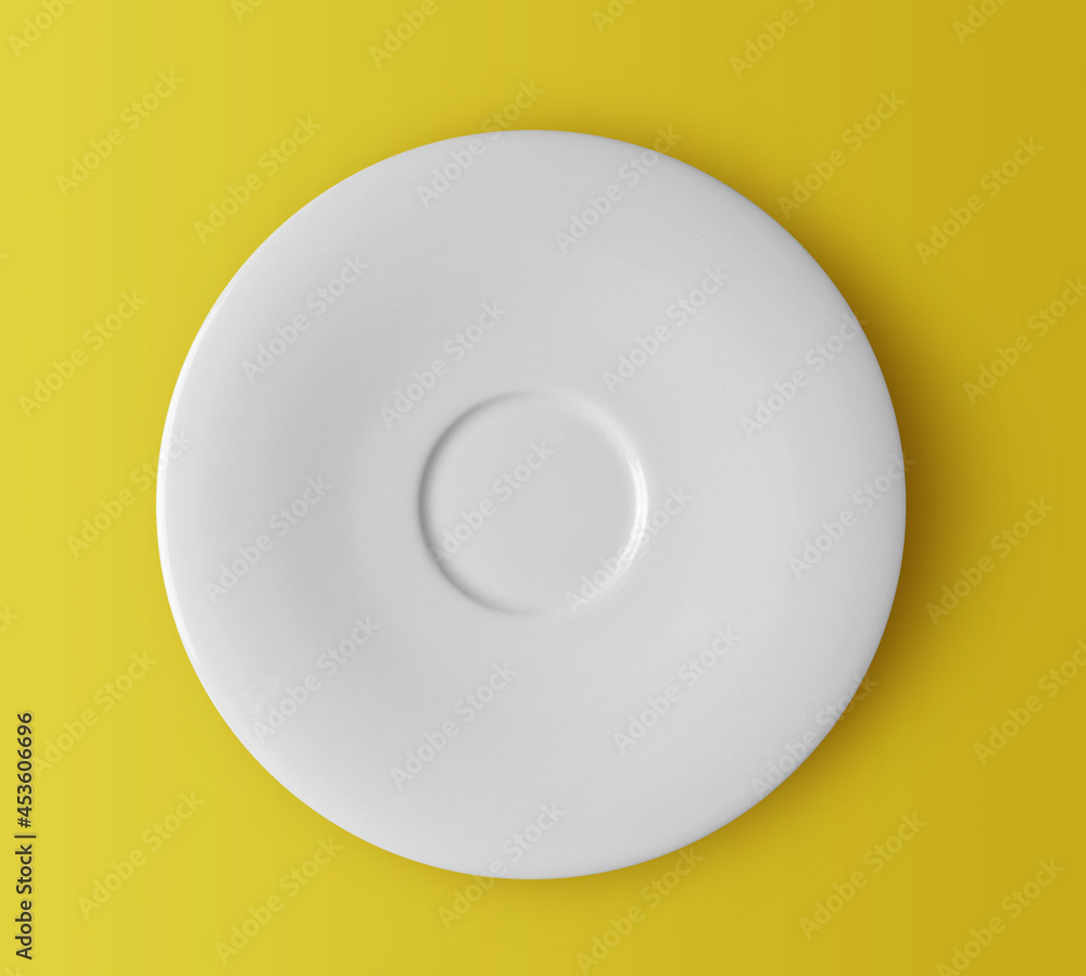 white ceramic plate on yellow white ceramic plate on yellow