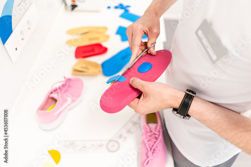 Orthopedic insole. The orthopedist works with the patient. Orthopedic clinic. Choice of insoles in an orthopedic clinic. The orthopedist offers the insole to the patient Foot care