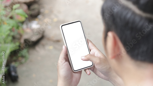 Wallpaper Mural Man's hands holding or using smartphone with two hands. Smartphone with white blank on screen, Cellphone mockup. Torontodigital.ca