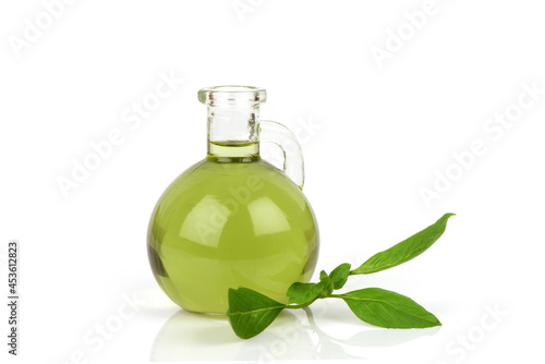 Sweet basil green leaves and oil isolated on white background.