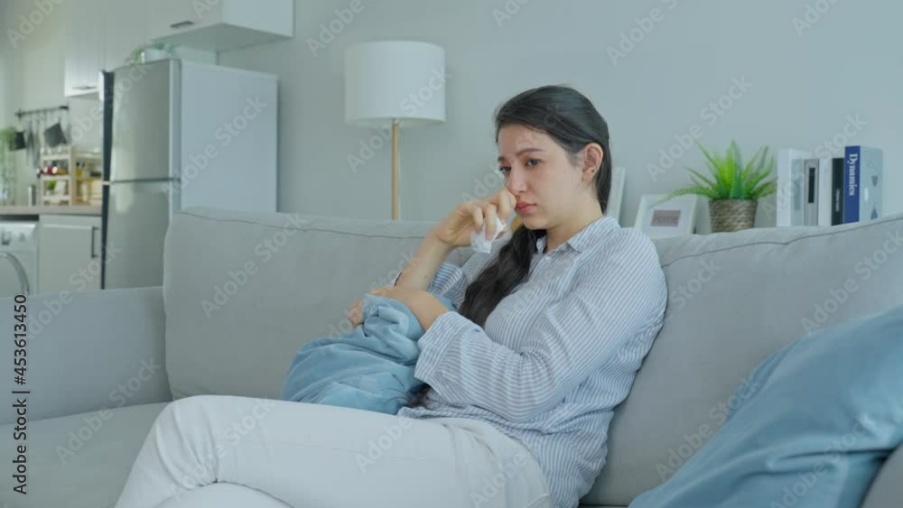 Asian beautiful unhappy woman sit on sofa feel frustrated and stressed Asian beautiful unhappy woman sit on sofa feel frustrated and stressed