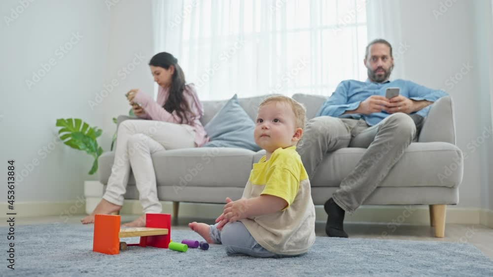 Caucasian phone addict parents don't pay attention with baby toddler. Caucasian phone addict parents don't pay attention with baby toddler.