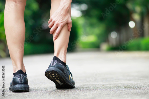A runner has a lot of leg pain at the park.