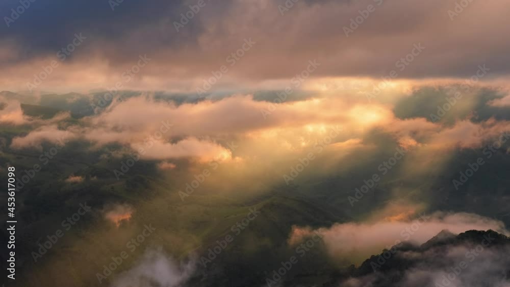 Low clouds over a highland plateau in the rays of sunset. Sunset on Bermamyt plateau North Caucasus, Karachay-Cherkessia, Russia. Low clouds over a highland plateau in the rays of sunset. Sunset on Bermamyt plateau North Caucasus, Karachay-Cherkessia, Russia.