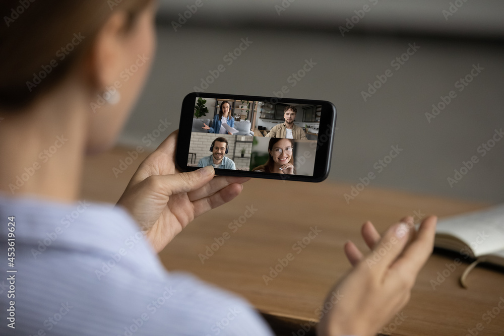 Close up cropped of woman holding phone, involved in group video call, chatting with friends in social network, businesswoman negotiating project with colleagues, communication and remote work