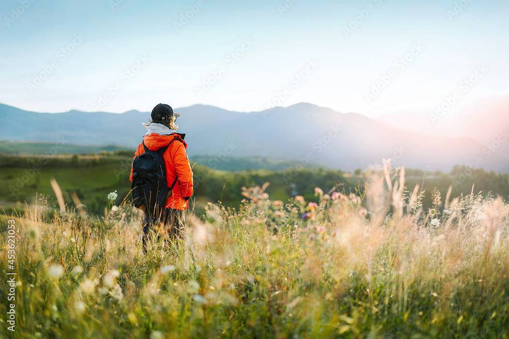 hiker in the mountains at sunset