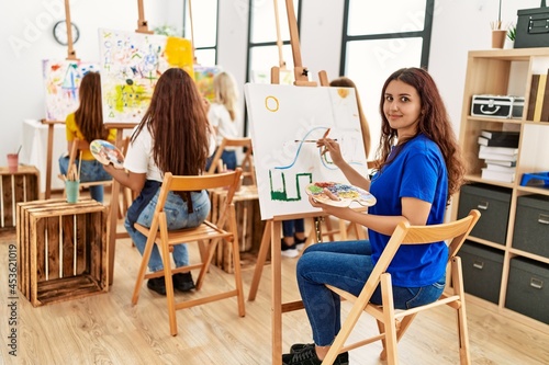 Group of young artist girls smiling happy drawing at art studio.