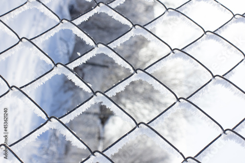 Grid photo the Chain-link covered with hoarfrost