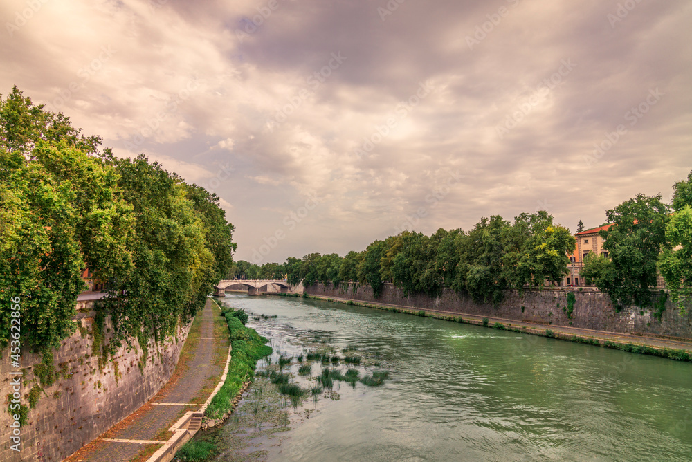 Sunset on a bridge on the Tiber river in Rome during summer Sunset on a bridge on the Tiber river in Rome during summer