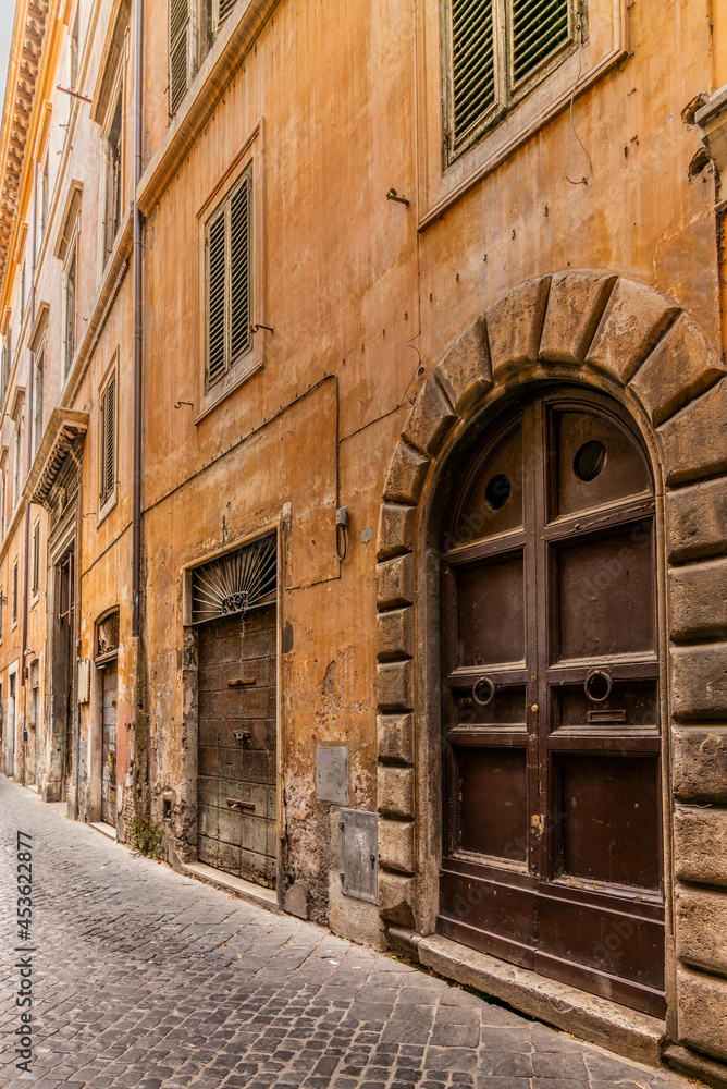 A cobbled old lane in Rome with old dilapided palaces