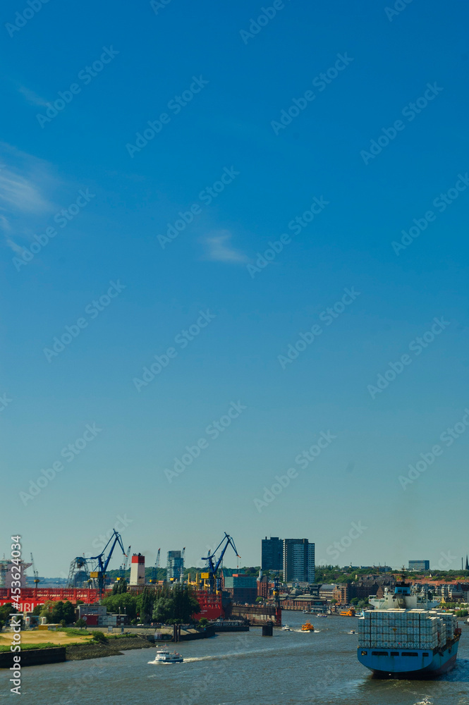 View over the port of Hambrug with cargo ships, cranes and wind turbines | Hamburg, Germany