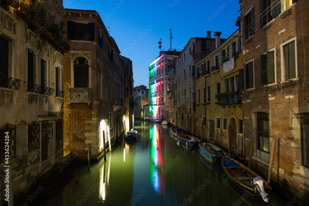 Venice cityscape, water canal at night, bridge and traditional buildings. Italy, Europe.
