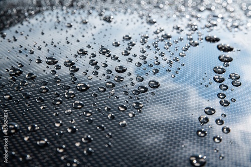 Water drops on car paint. Hydrophobic water effect on car body.