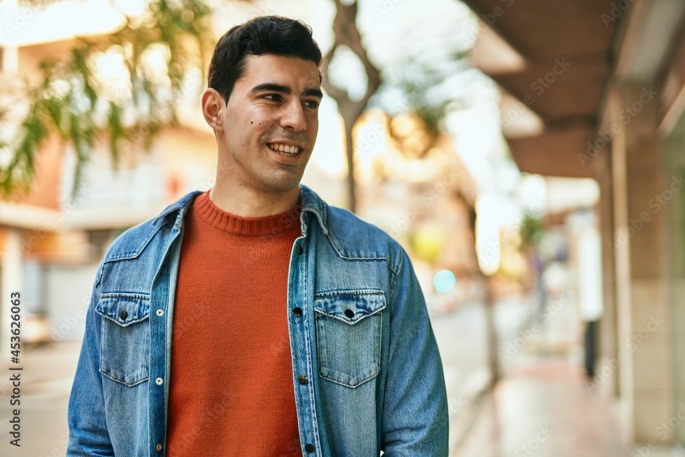 Young hispanic man smiling happy standing at the city. Young hispanic man smiling happy standing at the city.