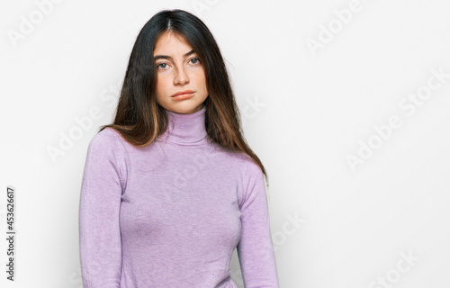 Young beautiful teen girl wearing turtleneck sweater looking sleepy and tired, exhausted for fatigue and hangover, lazy eyes in the morning.