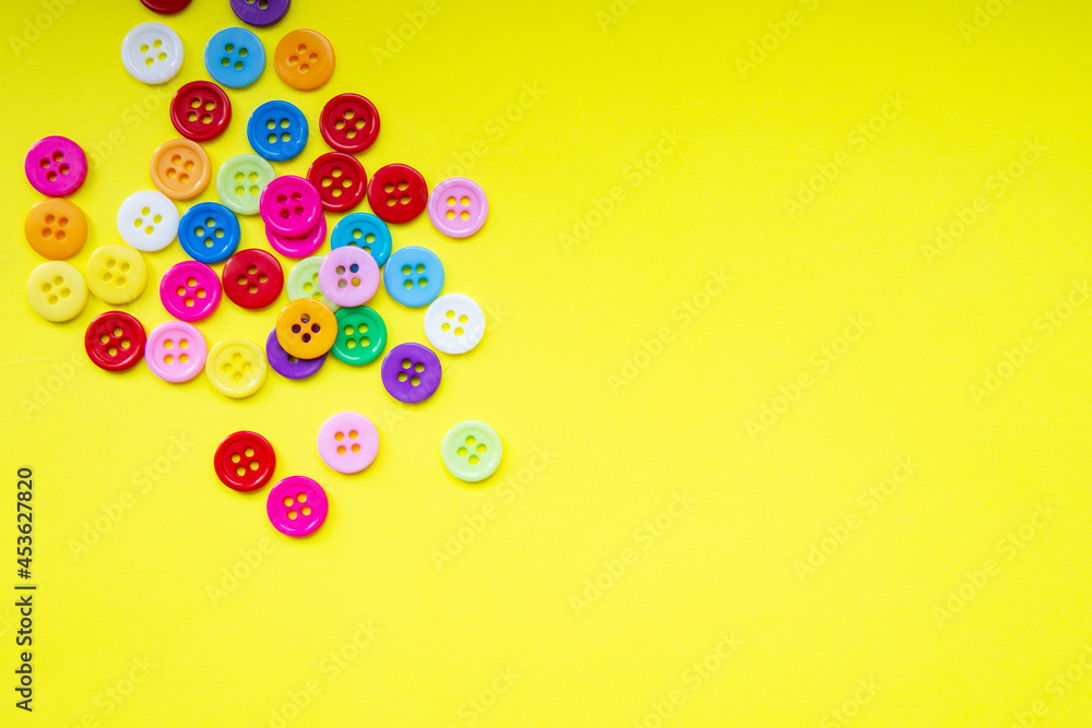 Cloth buttons on the yellow background with copyspace Cloth buttons on the yellow background with copyspace