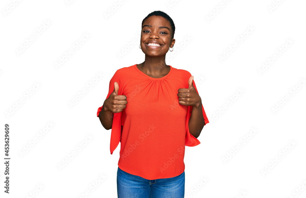 Young african american woman wearing casual clothes success sign doing positive gesture with hand, thumbs up smiling and happy. cheerful expression and winner gesture. Young african american woman wearing casual clothes success sign doing positive gesture with hand, thumbs up smiling and happy. cheerful expression and winner gesture.