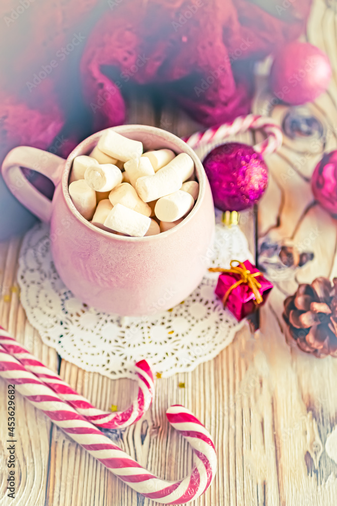 Christmas drink background, pink cup with hot chocolate and marshmallows on a wooden table near New Year's decor. Cocoa Christmas drink, copy space, bokeh effect, drink mug Christmas holiday Christmas drink background, pink cup with hot chocolate and marshmallows on a wooden table near New Year's decor. Cocoa Christmas drink, copy space, bokeh effect, drink mug Christmas holiday